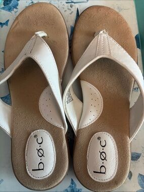 B.O.C. white thong sandals feature a cushioned, patterned tan footbed